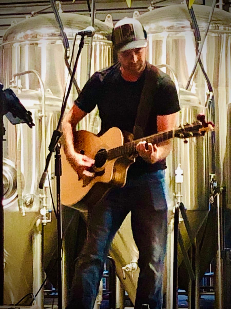 Nik Mathews performing at a brewery
